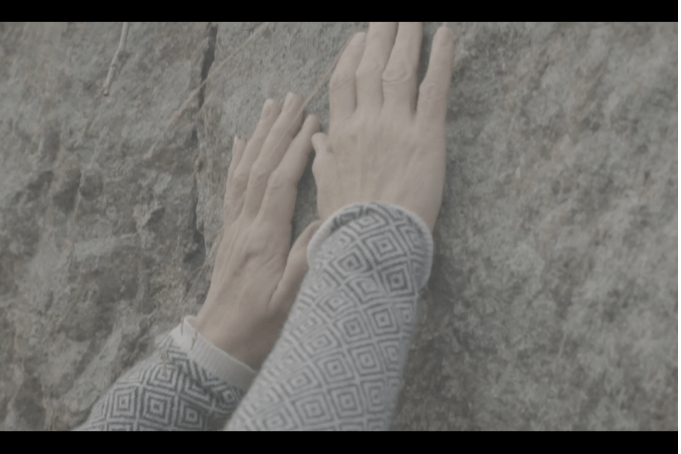 Participant interacting with an old stonewall on Kuninkaansaari